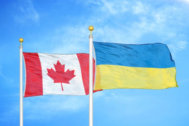 Canadian and Ukrainian flags flying together