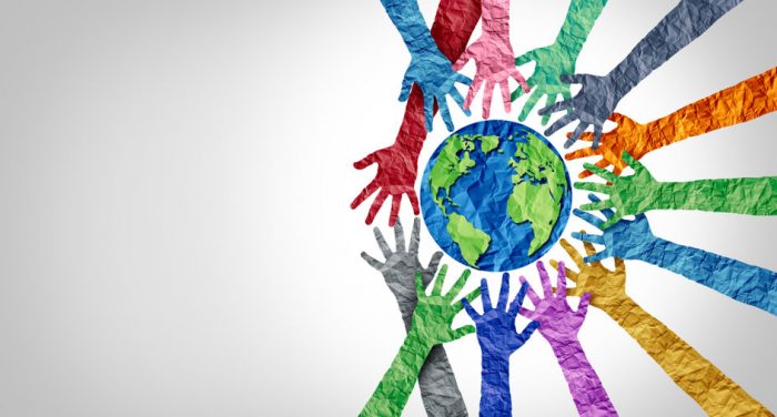 Hands of different colours reaching out to earth, symbolizing different cultures, diversity, cultural intelligence, CQ