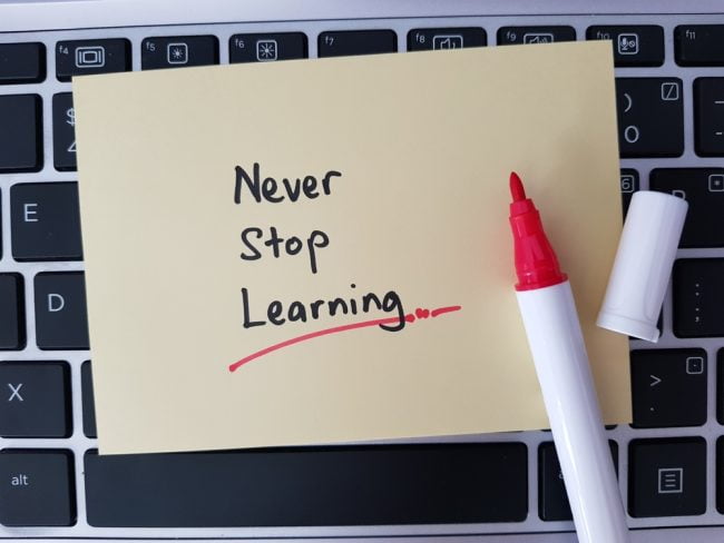 Sticky note reminder to never stop learning, representing the importance of continuous learning.